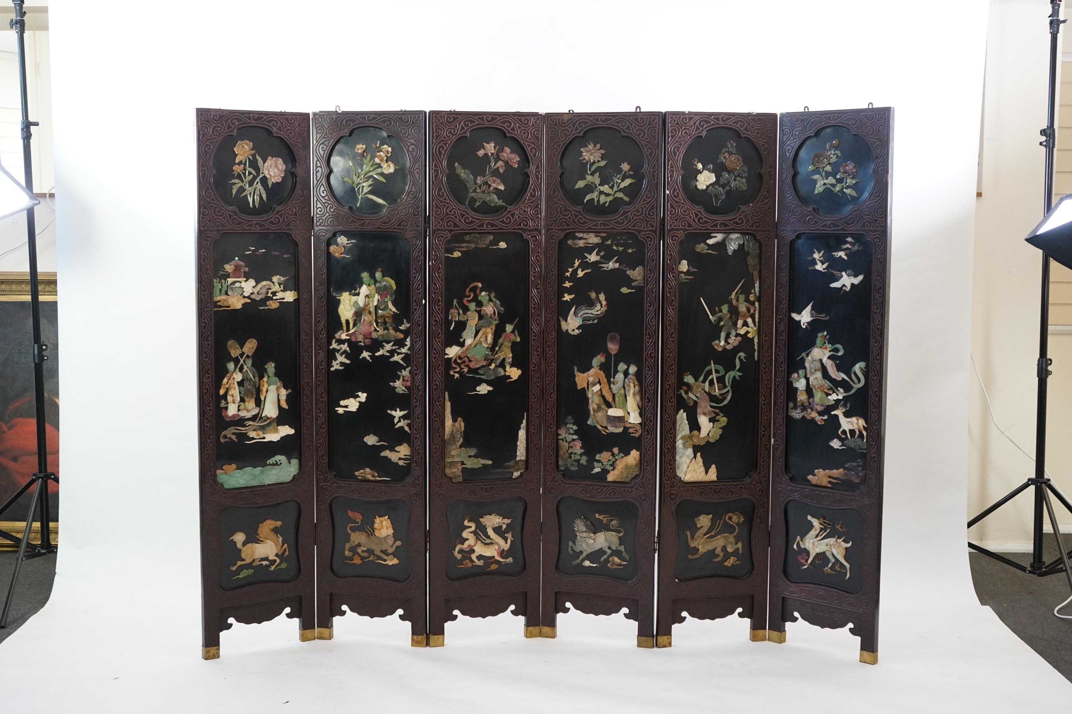 A Chinese tixi lacquer and carved soapstone overlaid six panel screen, mid 20th century